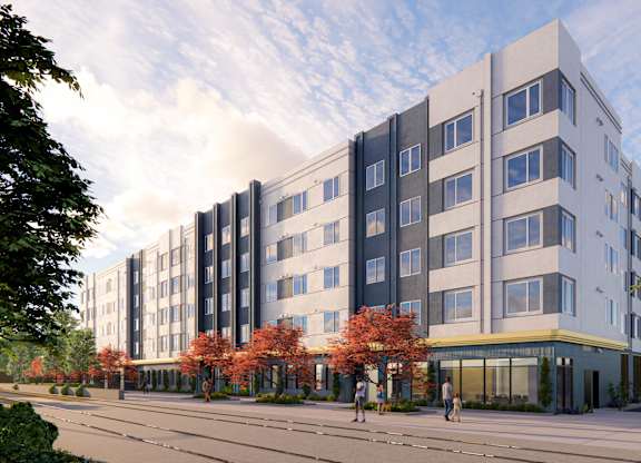 A modern multi-story building with a mix of grey and white exterior and a yellow accent on the ground floor at Rivo Apartments, Sacramento, 95815