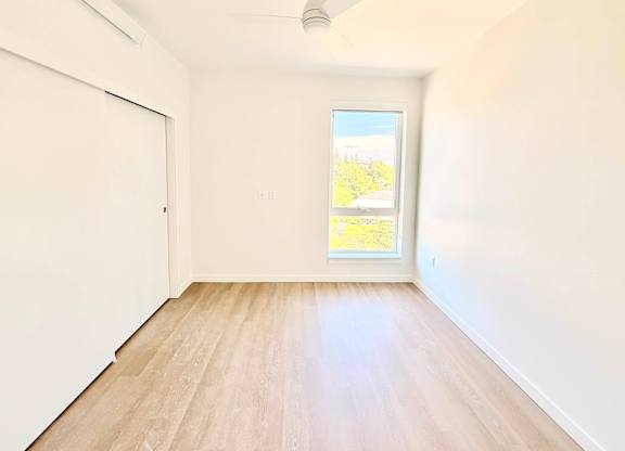 A room with a window and a sliding door.