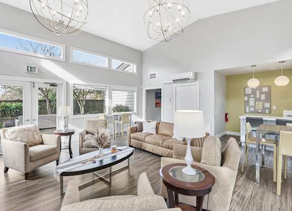 A living room with a couch, chairs, and a coffee table.
