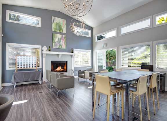 A modern living room with a fireplace and a dining table.