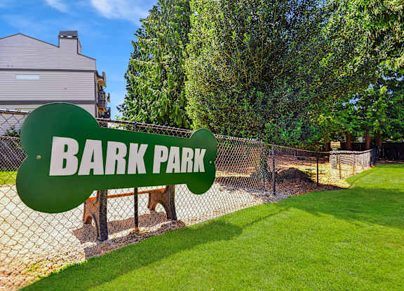 A green sign that says Bark Park in white letters.