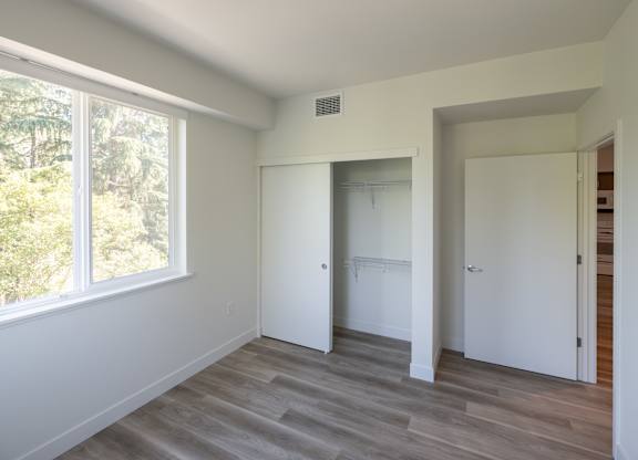 A room with a window and a door.