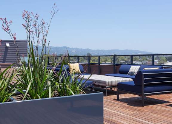 A wooden deck with a bench and a planter box at View Point Apartments, Berkeley, CA
