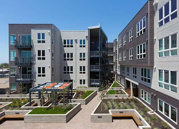 A modern apartment complex with a courtyard garden at View Point Apartments, Berkeley California