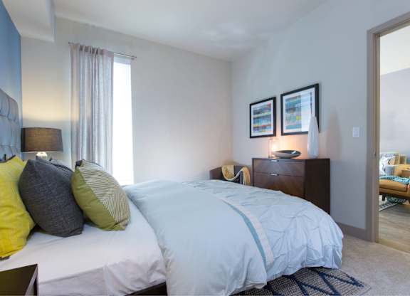 A bedroom with a large bed and a chair at View Point Apartments, Berkeley
