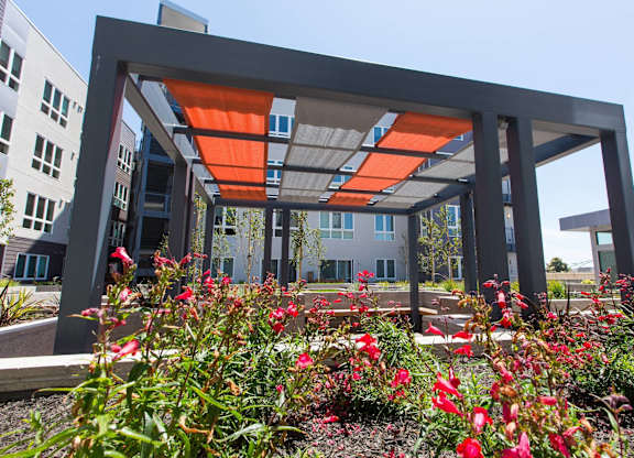 A modern building with a garden in front at View Point Apartments, Berkeley, 94710