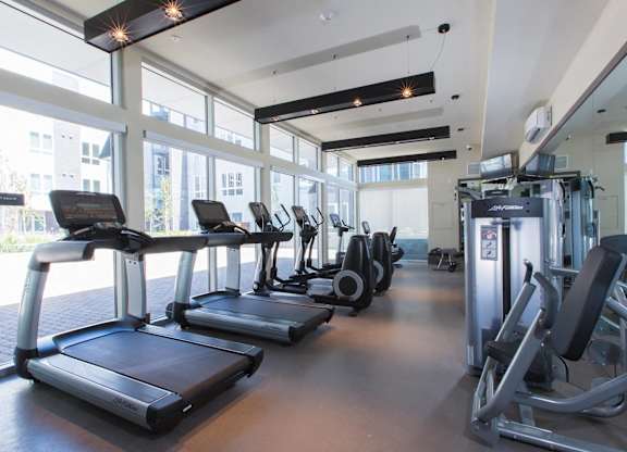 A gym with treadmills and exercise machine at View Point Apartments,California.