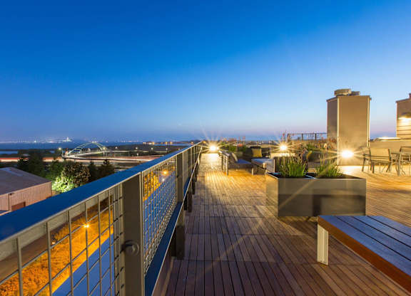 A rooftop deck with a railing and a bench at View Point Apartments, Berkeley, CA