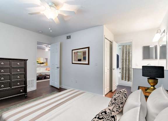 A living room with a black dresser and a white couch at Academy on Dean Woods Apartments, Florida