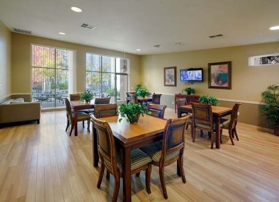 A dining room with a wooden table and chairs.