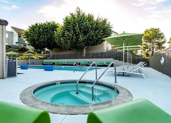 A round above ground pool with a hot tub in the middle.
