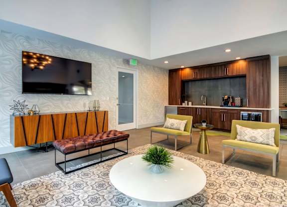 A modern living room with a flat screen TV mounted on the wall.