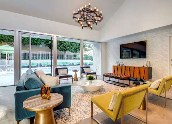 A living room with a yellow chair and a wooden table.