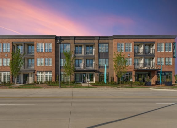 an exterior view of an apartment building on a city street