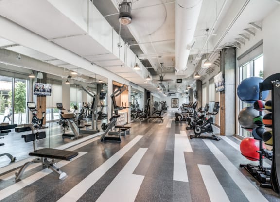 a spacious fitness center with treadmills and other exercise equipment