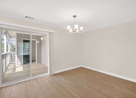 A room with wooden floors and a chandelier.