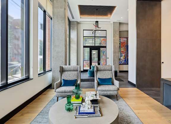 A modern living room with a grey sofa and a coffee table.