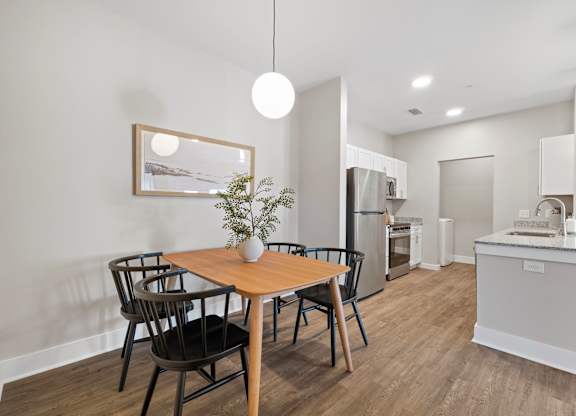 A modern kitchen with a dining table and chairs.
