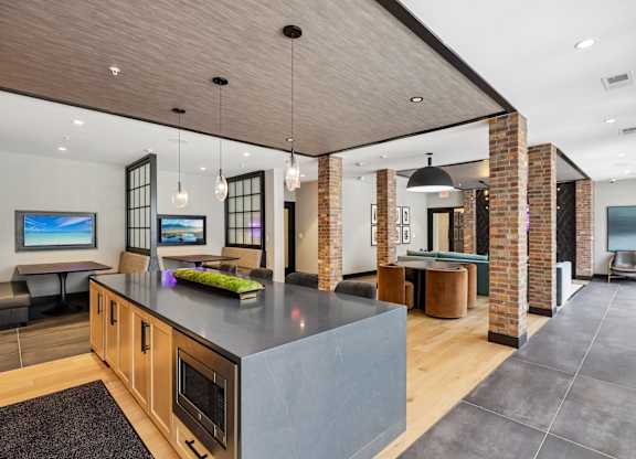 A modern kitchen with a large island and a dining area.