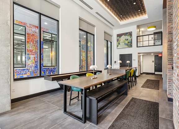 A modern kitchen with a long table and chairs.