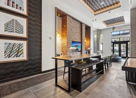 A modern dining area with a long table and chairs.
