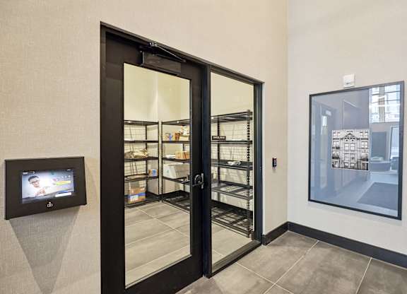 A black door with a glass window is open.