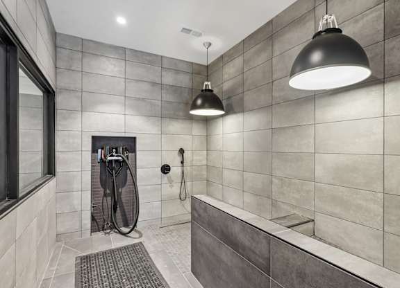 A bathroom with a shower and a window.