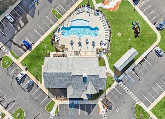 A large building with a pool in front of it.