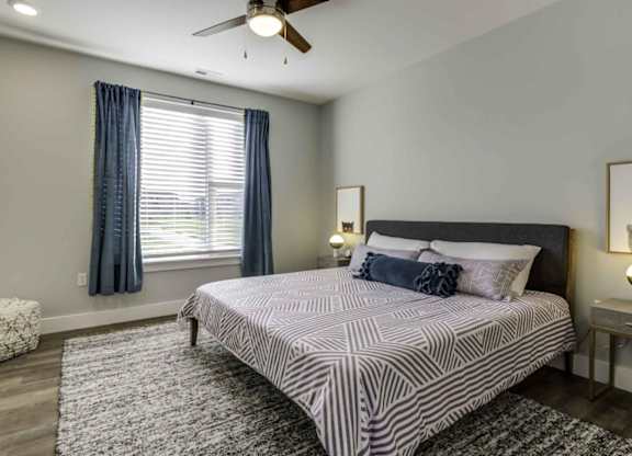 a bedroom with a bed and a ceiling fan at Echo Park at Perry Crossing Apartments, Plainfield, 46168