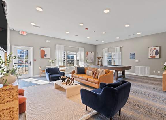 A spacious living room with a variety of furniture and decor.