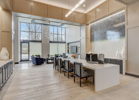an office space with a desk and chairs and a large window