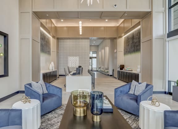 a living room with blue couches and a table