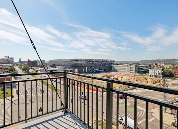 Private balcony at Contrast OTR apartments in Cincinnati, OH with sleek glass doors and city views.