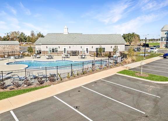 A large building with a pool in front of it.