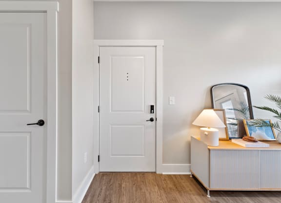 A white door is on the left and a white door with a black handle is on the right.