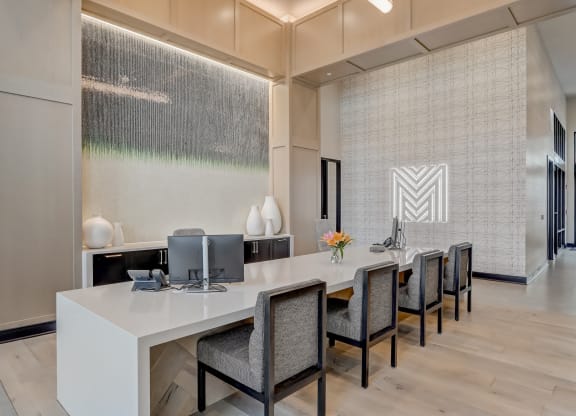 a modern office with a long desk and chairs