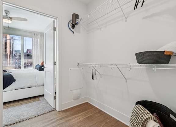 Spacious walk-in closet at Contrast OTR in Over-the-Rhine, Cincinnati with shelving and hardwood floors.