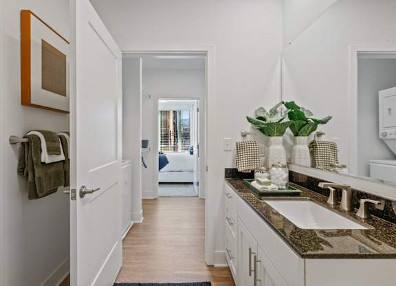 A bathroom with a white sink and a mirror above it.