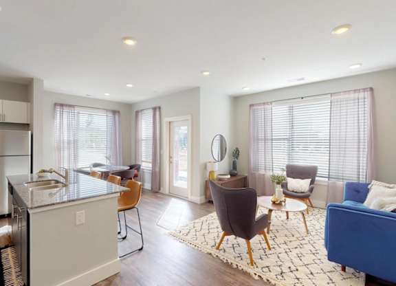 a living room with a kitchen and a dining room at Echo Park at Perry Crossing Apartments, Plainfield, IN