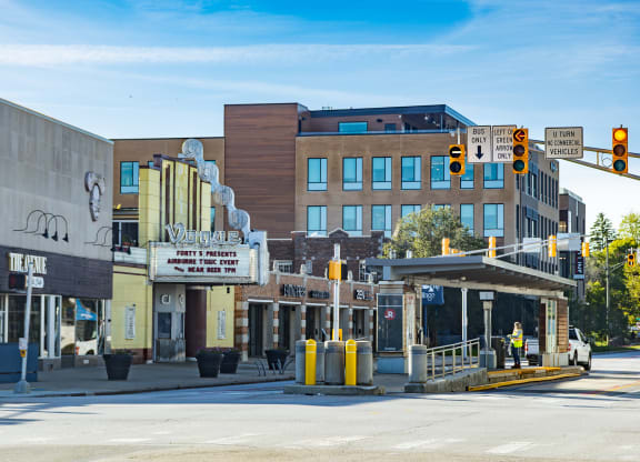 a city street with a building in the background and a traffic light