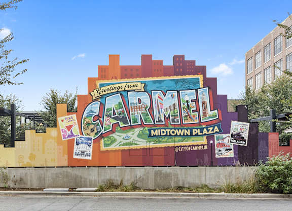 a large mural on the side of a building that reads carmel midtown plaza at Providence at Old Meridian Apartments , Carmel, IN