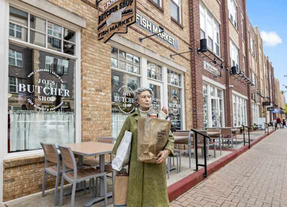 Woman standing on sidewalk at Governor Square Apartments, Carmel, IN