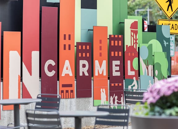 a sign for a restaurant with a city skyline on it at Providence at Old Meridian Apartments , Indiana