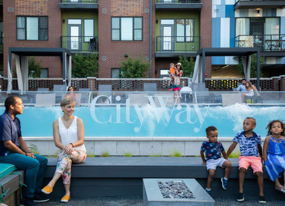 Outdoor gathering spot in front of infinity pool with benches, fire pits, grills and more