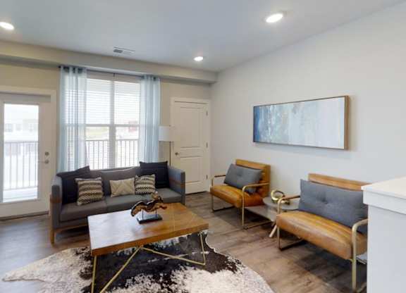 a living room with couches and a coffee table at Echo Park at Perry Crossing Apartments, Indiana