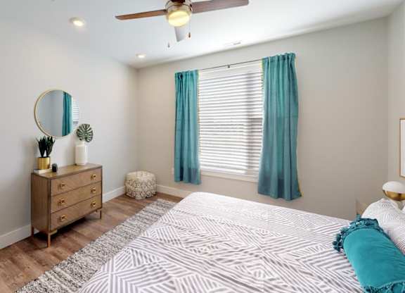a bedroom with a bed and a ceiling fan at Echo Park at Perry Crossing Apartments, Indiana