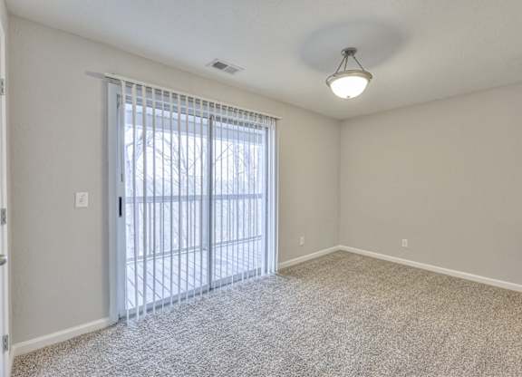 A room with a sliding glass door leading outside at Landmark at Lyncrest Reserve Apartments, Nashville, TN