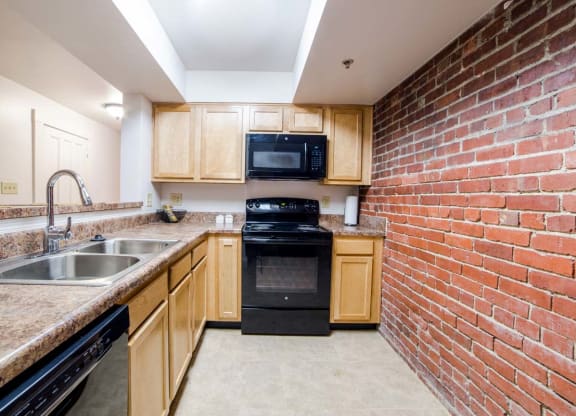 Modular Kitchen with Black Appliances wide view at Lockerbie Court on Mass Ave, Indianapolis, Indiana