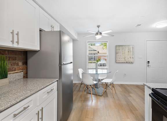 Bright dining nook at Monon Living with ceiling fan and wood-style flooring, located in Broad Ripple near trailheads and local coffee shops.