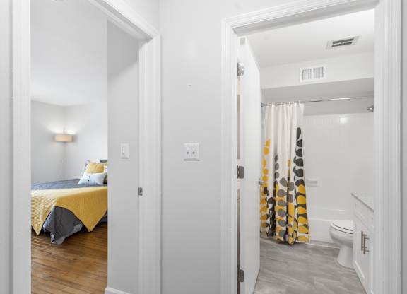 View of connected bedroom and bathroom layout at Monon Living in Broad Ripple, perfect for convenient living steps from the Monon Trail.